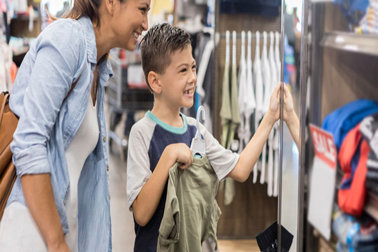 mother helps son shop for back-to-school supplies