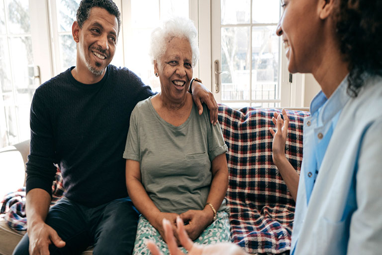 two younger men share a laugh with an older woman