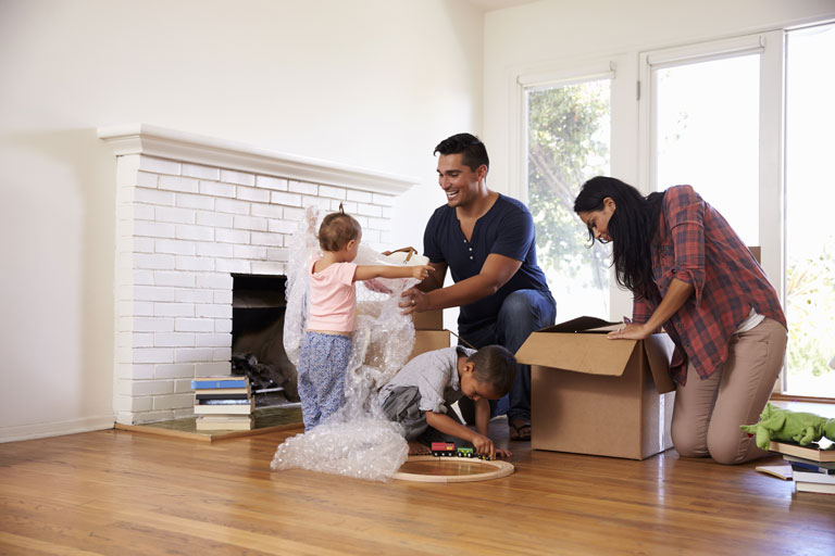 A family unpacking boxes in a new home.