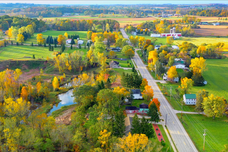 A rural town with lots of trees in fall.