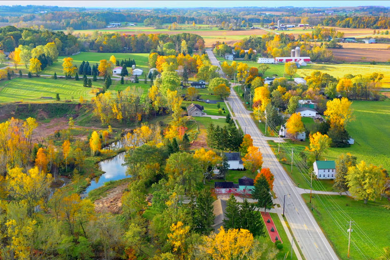 A rural town with lots of trees in fall.