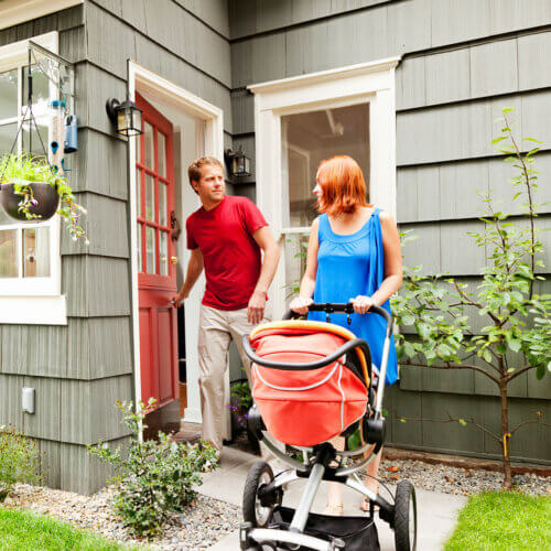 Couple going for a walk with baby stroller