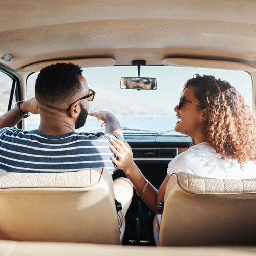 Couple in a car laughing together