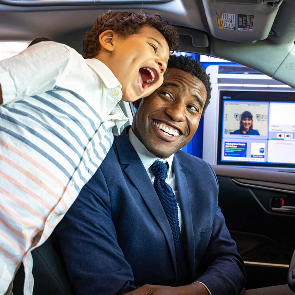 Dad and son in their car at an ITM