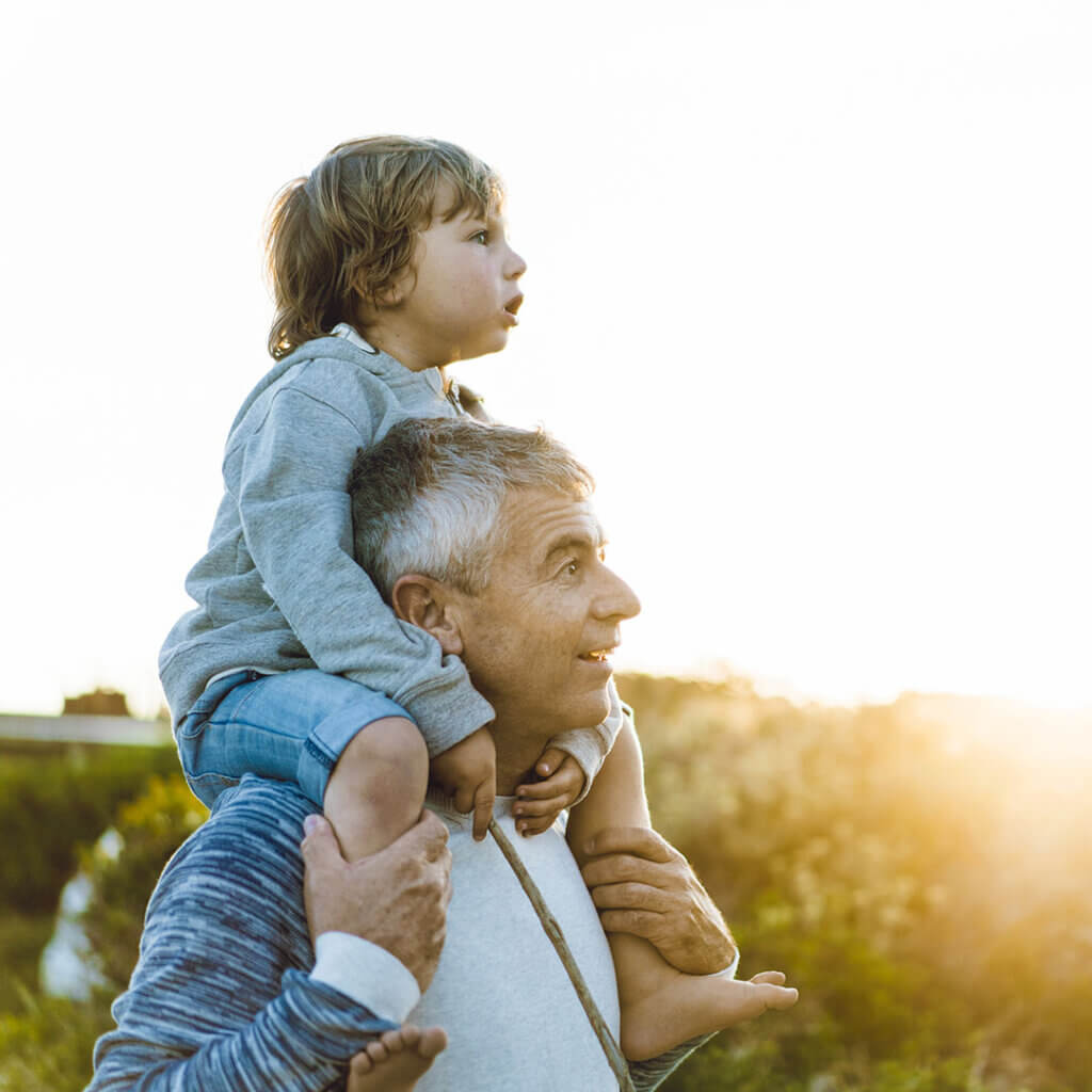 Man with a young boy on his shoulders