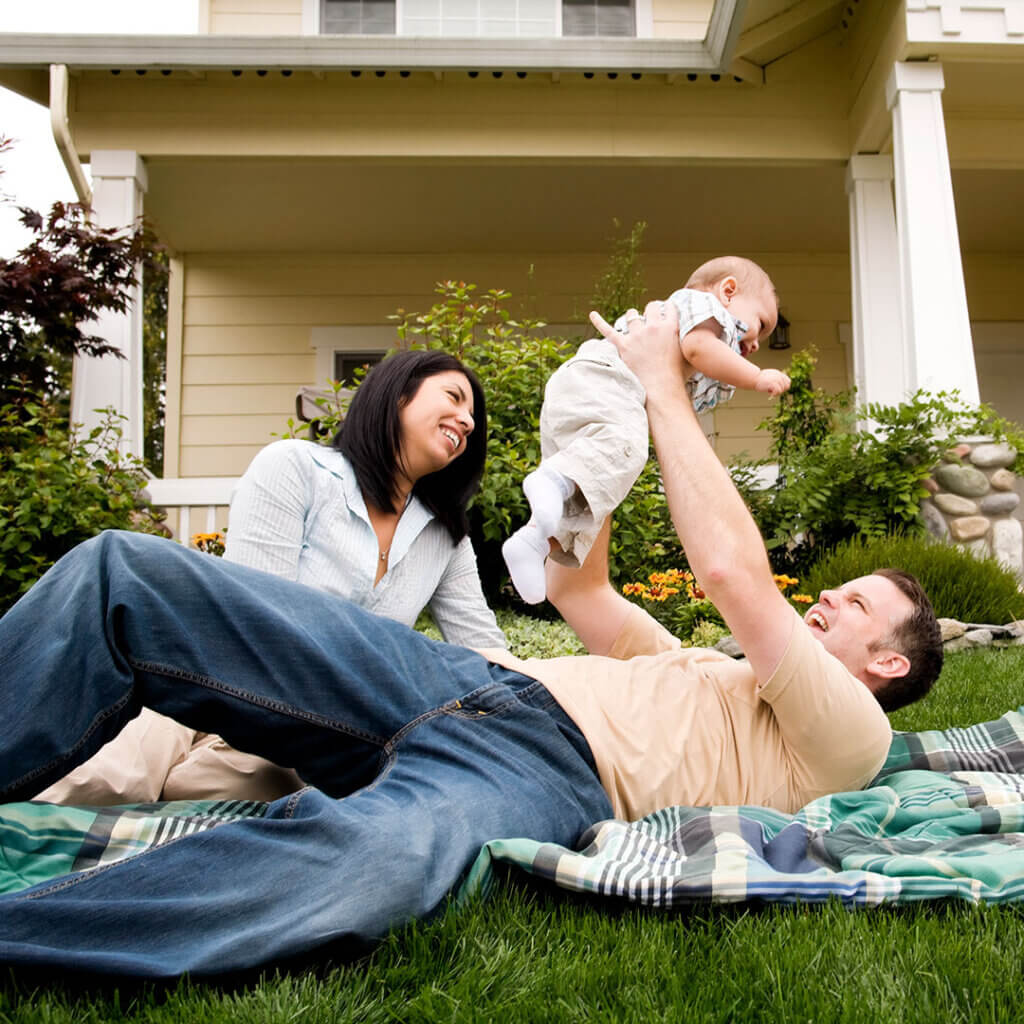 Family laying outside on the lawn together
