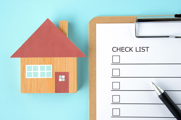 A tiny house next to a check list.