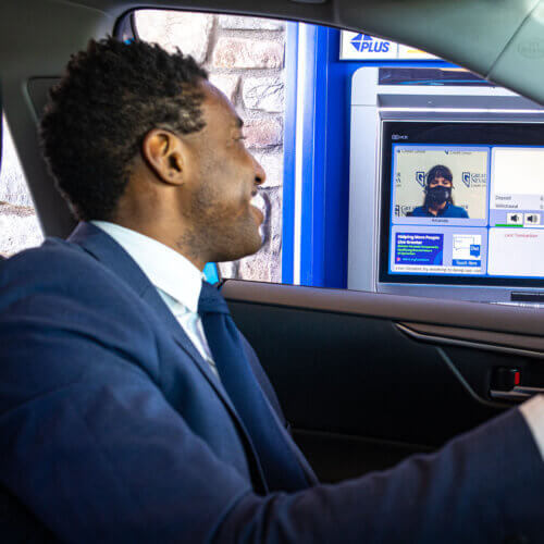Man using an interactive teller machine (ITM)