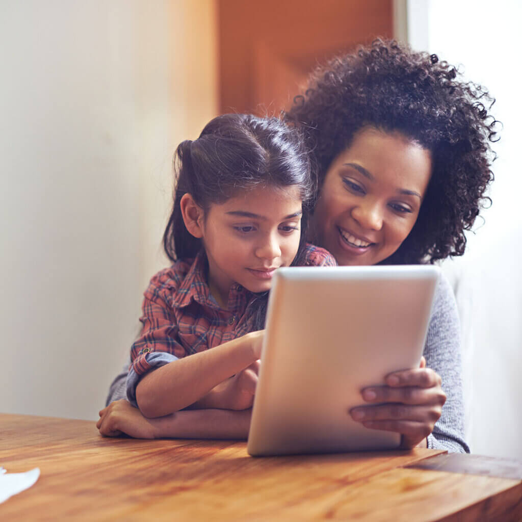 Mom and young daughter using a tablet together