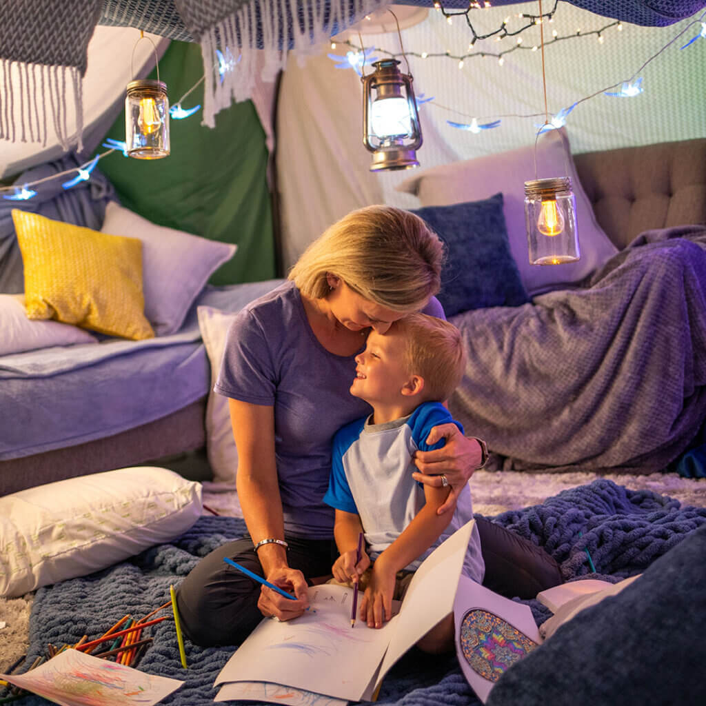 Mom and son in a living room fort