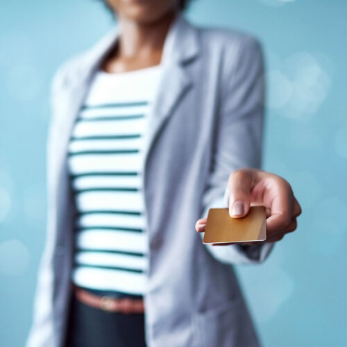 Woman holding an example credit card