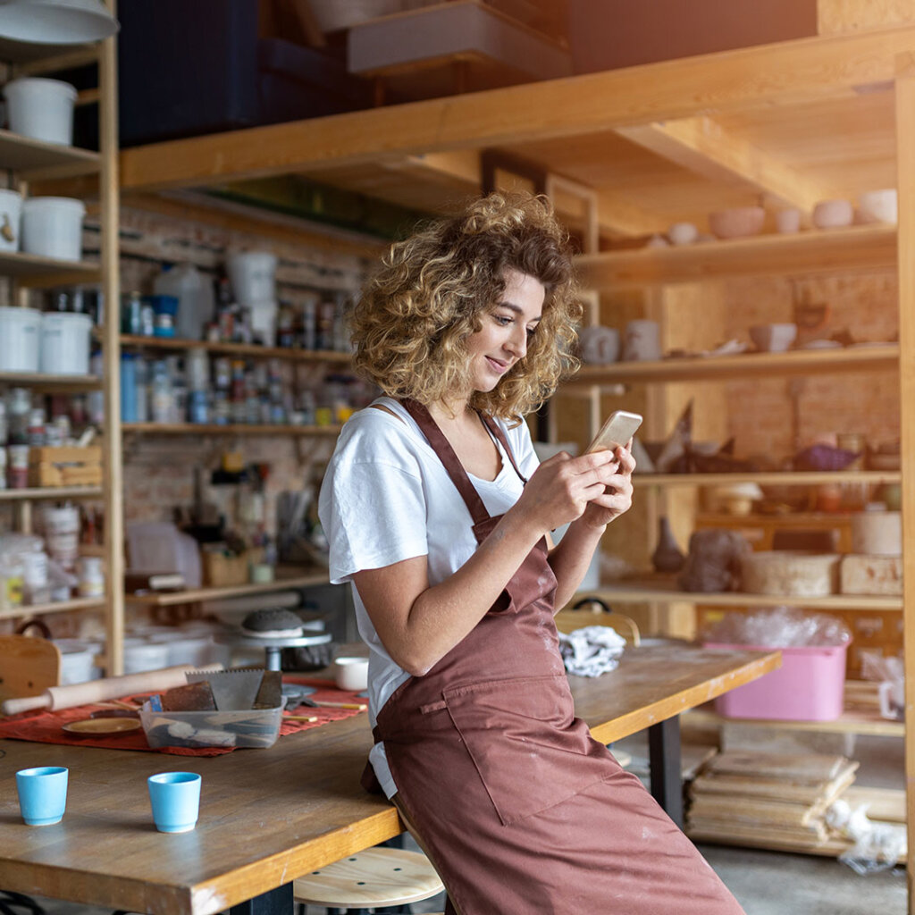 Female small business owner on smartphone