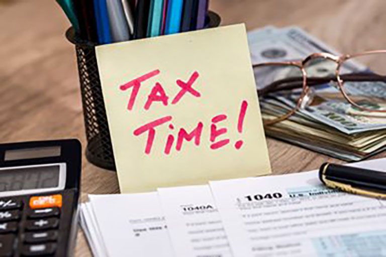 tax forms and note saying TAX TIME!