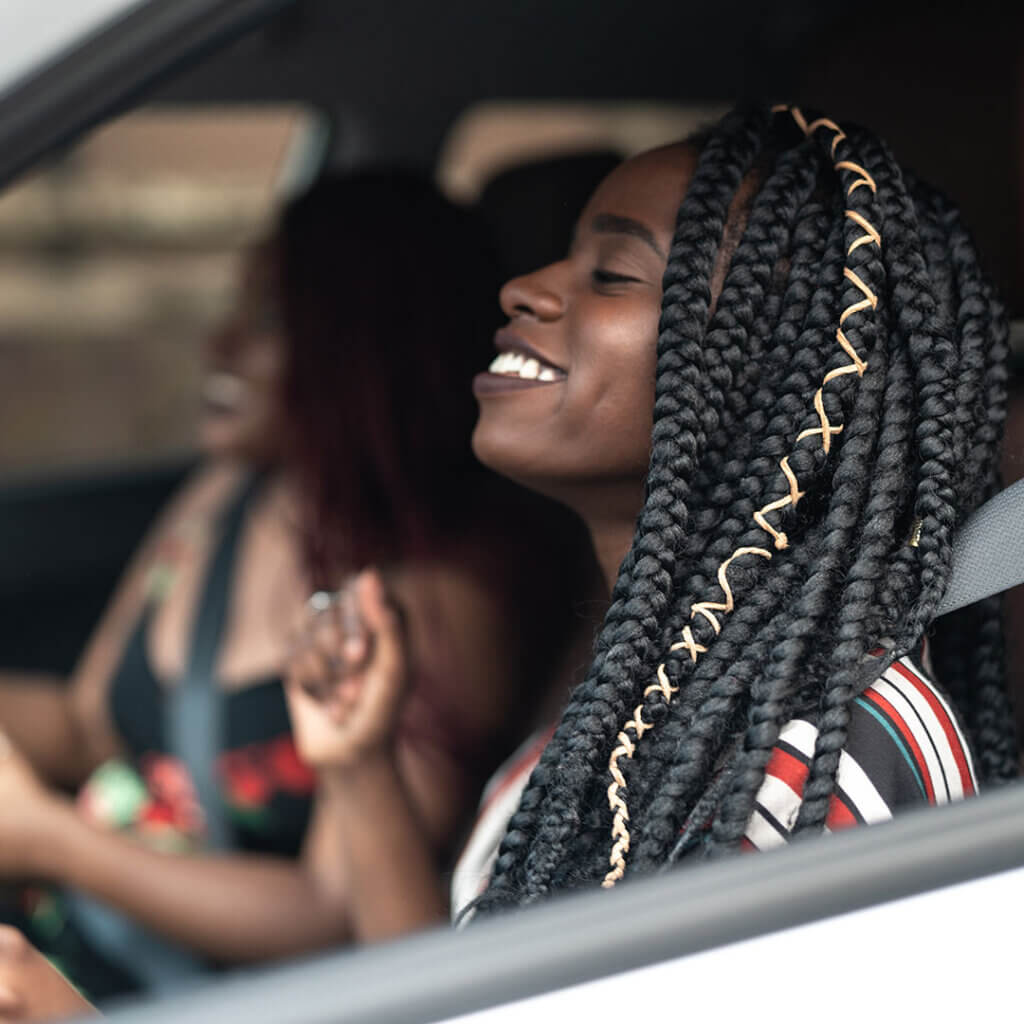 Two women having fun together in a car