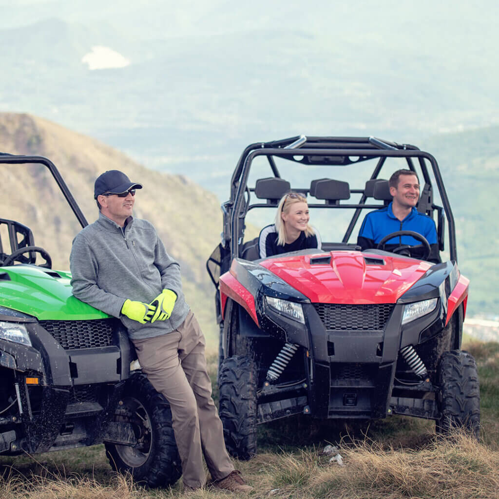 Friends in UTVs together outdoors