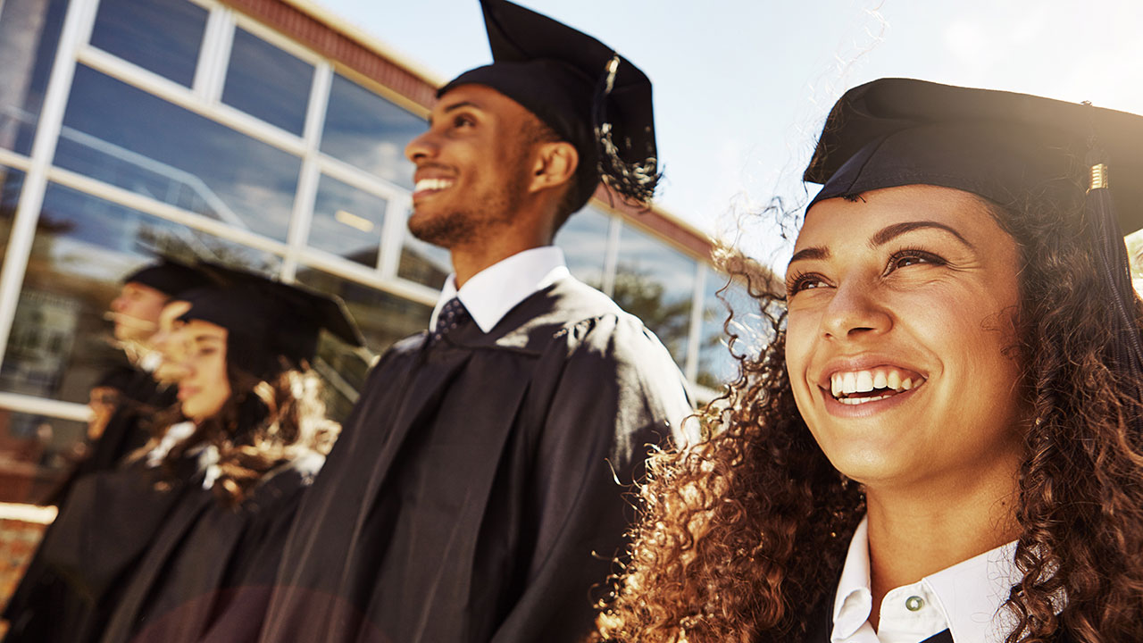 College graduates standing in a line together