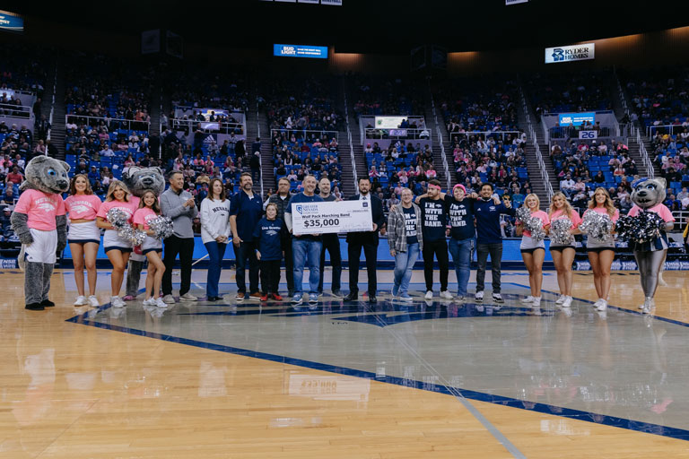 2023 check presentation with GNCU and UNR leaders at Wolf Pack basketball game