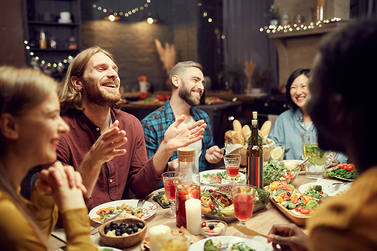 A group of people having fun at a dinner inside someone's home.