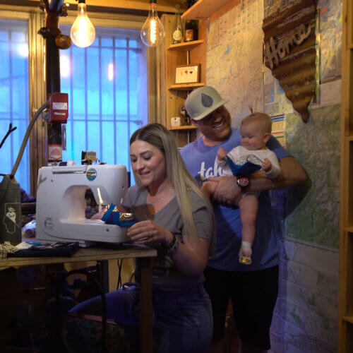 Small business owners couple with baby