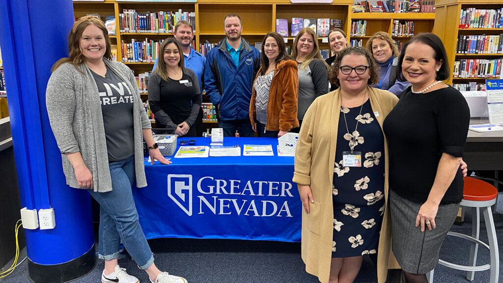 Group photo of GNCU employees inside a library