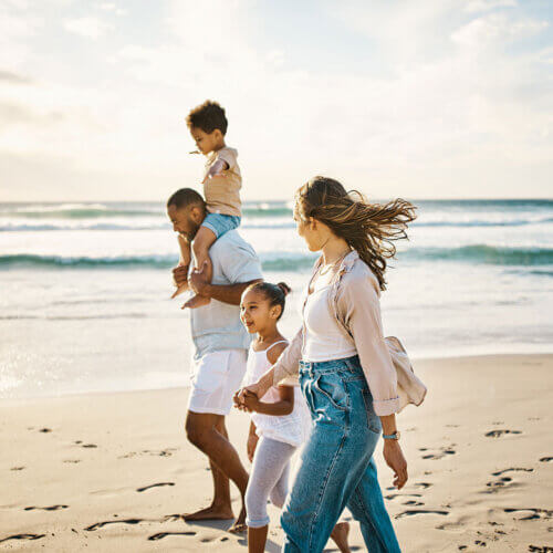 Family walking together on an ocean's beach