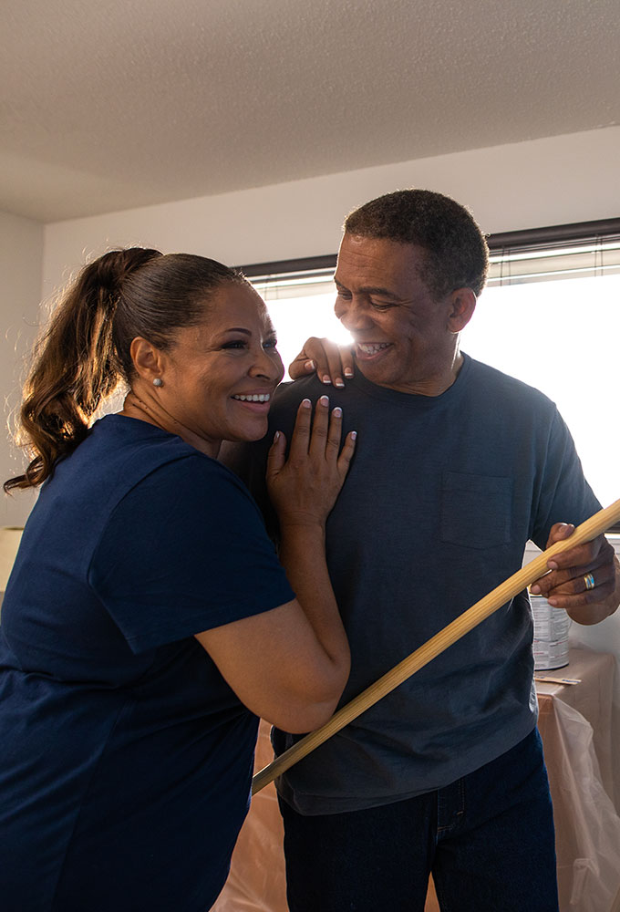 Couple painting a room together