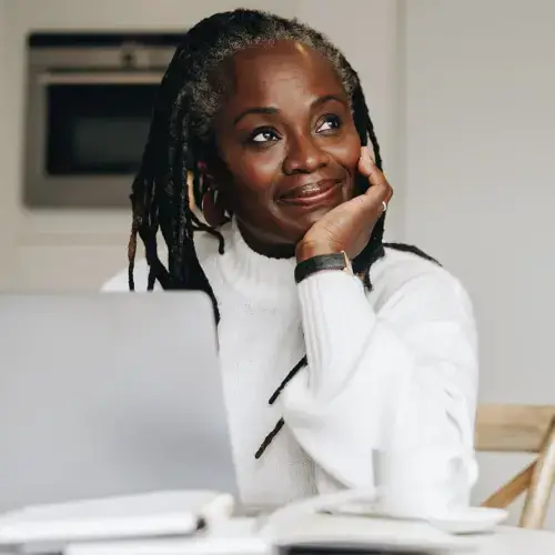 Woman smiling while sitting at her laptop