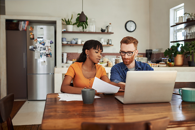 Couple looking at paperwork together while contemplating debt consolidation options