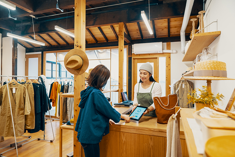 Female business owner accepting mobile payment on small business saturday