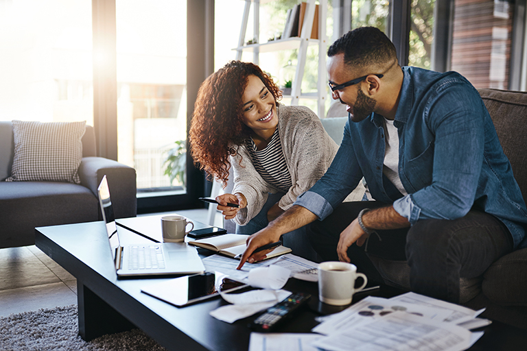 Shot of a young couple planning their budget together at home