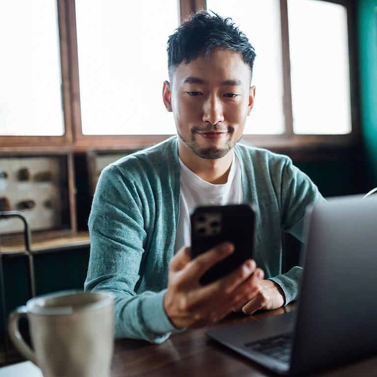 Man doing mobile and online banking from home