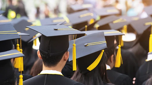 Group of students at graduation wearing caps and gowns