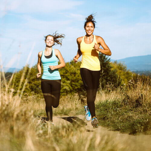 Two women running outdoors