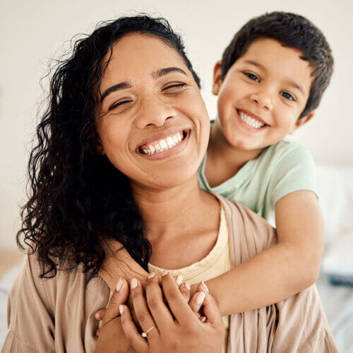 Mom and son smiling at the camera