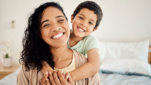Mom and son smiling at the camera