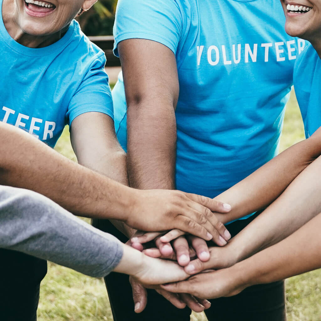 Volunteers with hands in