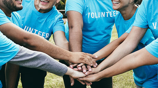 Volunteers with hands in