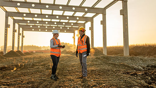 Two construction employees talking