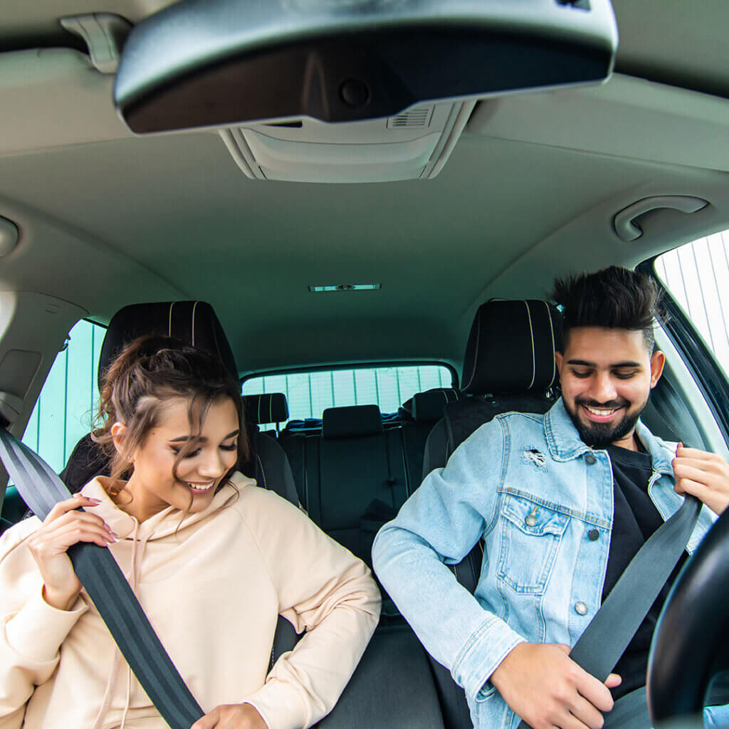 Couple buckling seat belts in a car