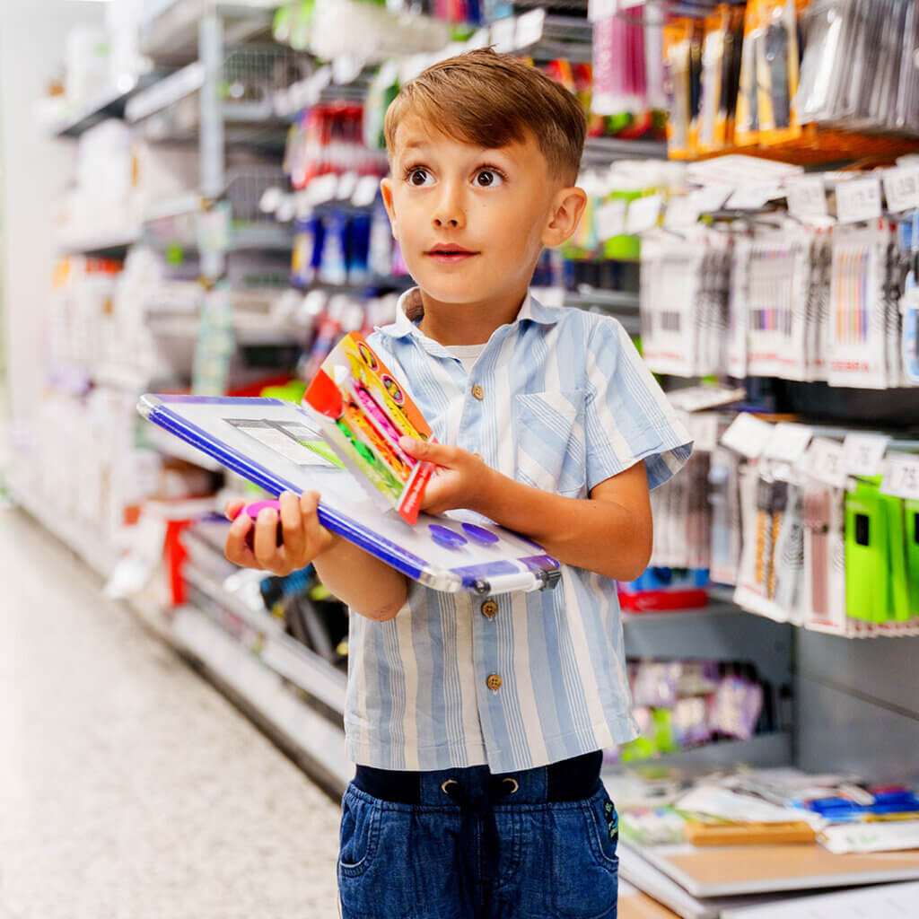 Young boy shopping for school supplies