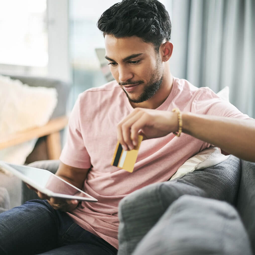 Man on his tablet using a debt-to-income calculator to find his debt-to-income ratio