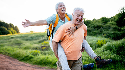 Couple doing a piggy back while outdoors