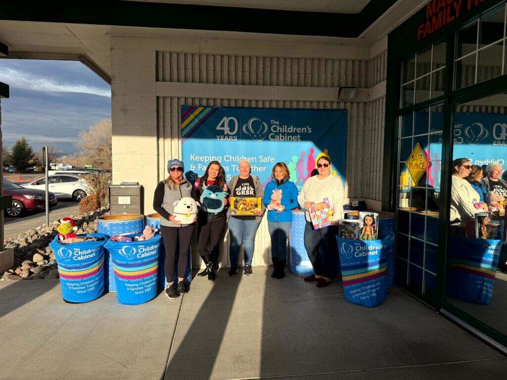 Greater Nevada employees holding toy donations at The Children's Cabinet