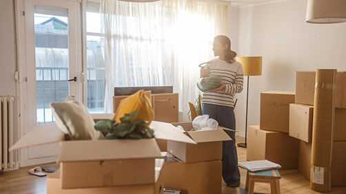 Woman with moving boxes in her new house