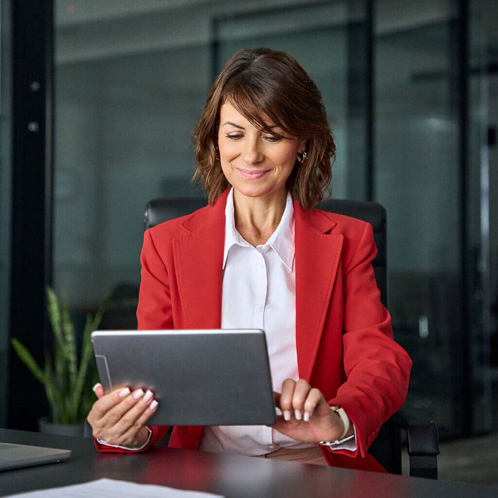 Business professional on tablet reviewing business services available at Greater Nevada