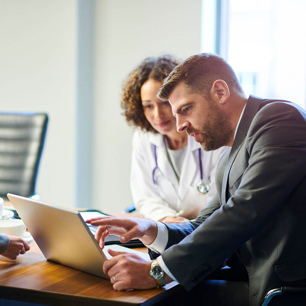 Administrative executive and doctor looking at their business high-yield money market account details for their practice