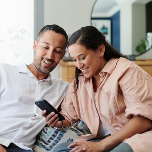 Couple watching webinar on smartphone together