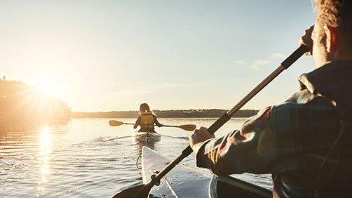 Couple kayaking on a lake together