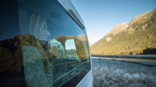Woman looking out the window of her RV